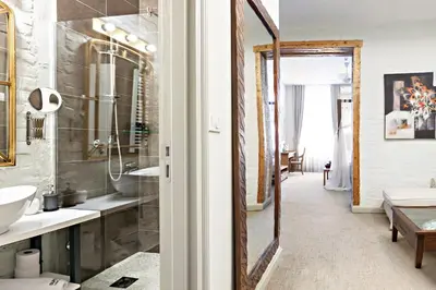 a bathroom with a sink and a mirror at SuperB Luxury Suites in Belgrade
