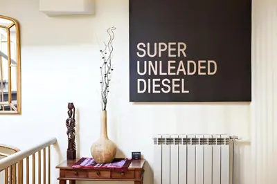 a vase on a table in a room with a sign at SuperB Luxury Suites in Belgrade