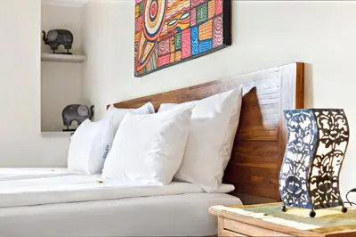 a bedroom with two beds with white pillows at SuperB Luxury Suites in Belgrade