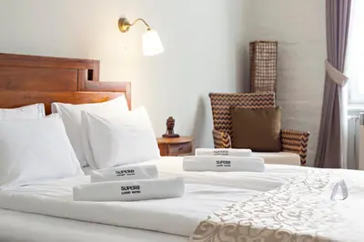 a bedroom with two beds with white pillows at SuperB Luxury Suites in Belgrade