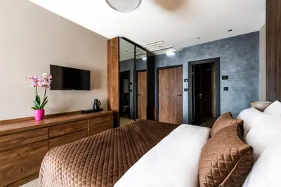 a bedroom with a bed and a tv on the wall at Amsterdam Hotel in Belgrade