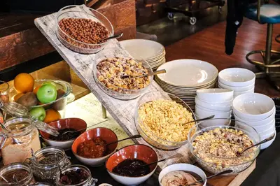 a table topped with bowls of food and bowls of nuts at Amsterdam Hotel in Belgrade