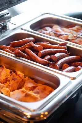 a bunch of hot dogs are in trays at Amsterdam Hotel in Belgrade