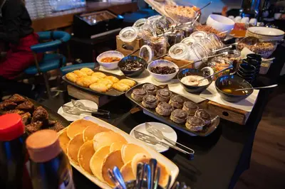 a buffet with many different types of food on a table at Amsterdam Hotel in Belgrade