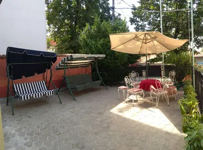 a patio with a table and an umbrella and chairs at Resident hill resort in Belgrade