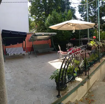 a patio with an umbrella and a table and chairs at Resident hill resort in Belgrade