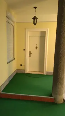 a room with a green floor and a door at Resident hill resort in Belgrade