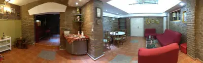 a room with red chairs and a table in a building at Resident hill resort in Belgrade