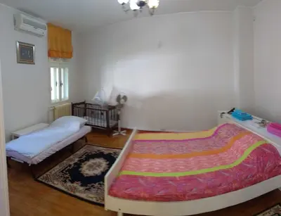 a bedroom with two beds and a rug at Resident hill resort in Belgrade