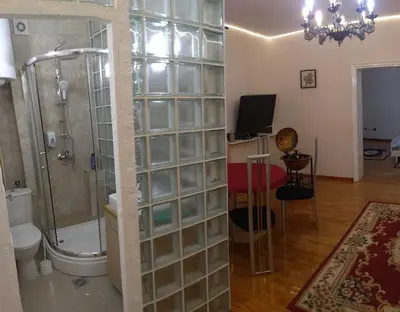 a bathroom with a shower with a glass block wall at Resident hill resort in Belgrade