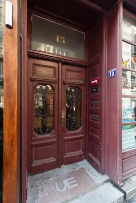 a wooden entrance to a building with two doors at Central Apartments in Belgrade