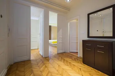 a room with a mirror and a dresser with a television at Central Apartments in Belgrade