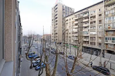 a view of a street with parked cars and buildings at Apartment Paradise Symphony in Belgrade