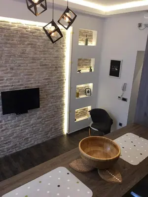 a living room with a large wooden bowl on a table at Al Mattina Apartments Belgrade in Belgrade