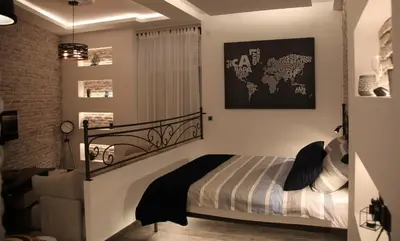 a bedroom with a bed with a black and white blanket at Al Mattina Apartments Belgrade in Belgrade