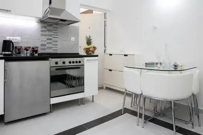 a kitchen with a stainless steel stove and a table at Natalie's Studio in Belgrade
