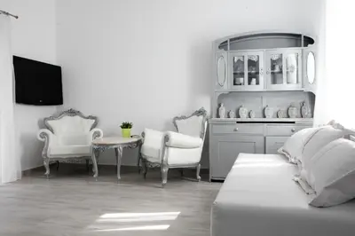 a living room with a couch and chairs and a table at Natalie's Suite in Belgrade