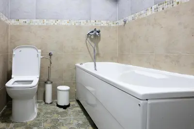 a bathroom with a toilet and a tub and a sink at Natalie's Suite in Belgrade