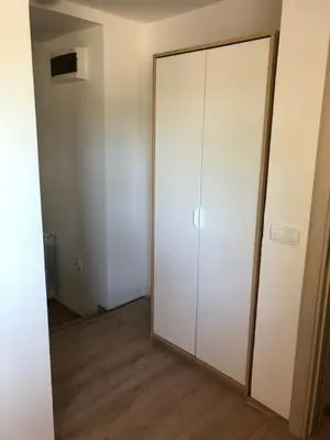 an empty room with a white closet and a door at Small & Sweet Apartments in Belgrade