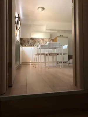 a dining room with a white table and chairs at Small & Sweet Apartments in Belgrade