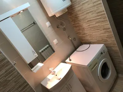 a bathroom with a toilet and a sink and a mirror at Small & Sweet Apartments in Belgrade