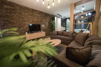 a living room with a couch and a tv at Empire Luxury Apartments in Belgrade