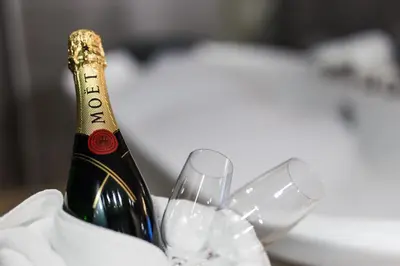 a bottle of champagne and a wine glass at Empire Luxury Apartments in Belgrade