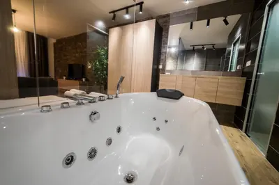a large white bath tub in a bathroom at Empire Luxury Apartments in Belgrade