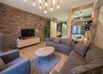 a living room with two couches and a tv at Empire Luxury Apartments in Belgrade