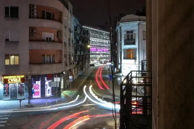 a view of a city street at night with cars at Natalie's Residence in Belgrade