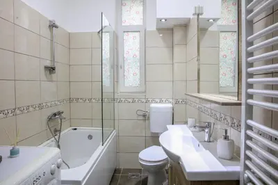 a bathroom with a toilet and a sink and a bath tub at Natalie's Residence in Belgrade