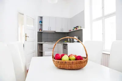 a basket of fruit on a counter in a kitchen at Hearth of Belgrade apartment in Belgrade