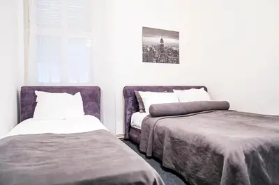 a bedroom with two beds and a window at Hearth of Belgrade apartment in Belgrade