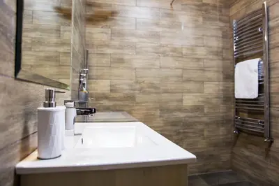 a bathroom with a white sink and a shower at Hearth of Belgrade apartment in Belgrade