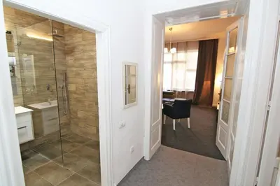 a bathroom with a shower and a sink and a desk at Hearth of Belgrade apartment in Belgrade