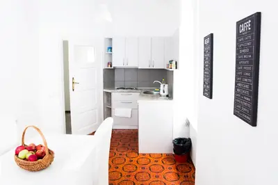 a kitchen with a table and a basket of fruit at Hearth of Belgrade apartment in Belgrade