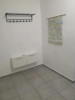 a room with white walls and a map on the wall at Hearth of Belgrade apartment in Belgrade