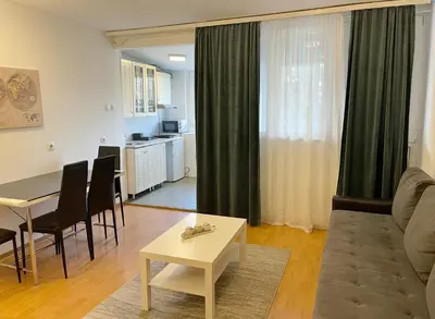 a living room with a couch and a table at Cherry Apartment Arena in Belgrade