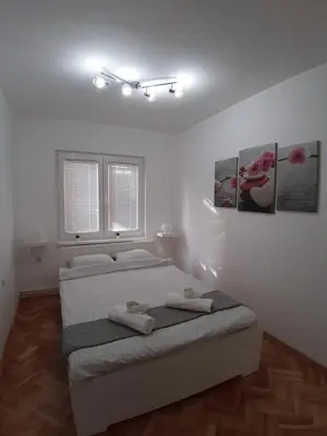a bedroom with a bed with two towels on it at Apartment Teodora in Belgrade
