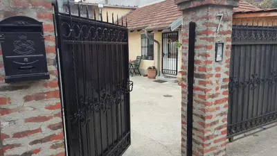 a black gate on the side of a brick building at Green point Apartments in Dušanovac (historical)
