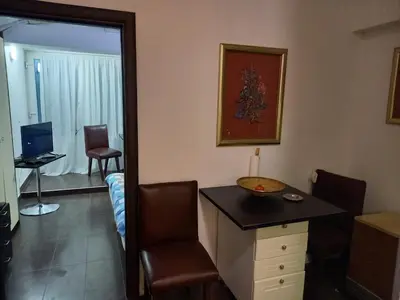 a room with a desk and a chair in a room at Green point Apartments in Dušanovac (historical)
