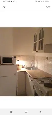 a kitchen with a sink and a refrigerator and a stove at Monia Dream Apartment - Belgrade Lake & Fair in Belgrade