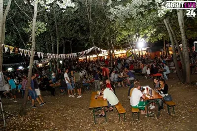 a crowd of people sitting at tables at a market at night at Monia Dream Apartment - Belgrade Lake & Fair in Belgrade