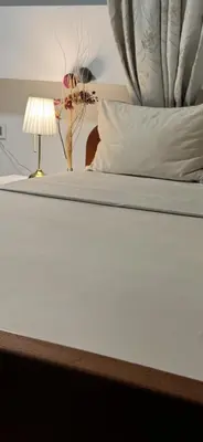 a bed with a lamp on top of it at Monia Dream Apartment - Belgrade Lake & Fair in Belgrade