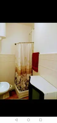 a bathroom with a shower curtain and a sink at Belvedere city center apartment in Belgrade