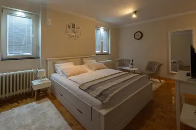 a bedroom with a bed and a tv in it at Atelje Knez Mihailova in Belgrade