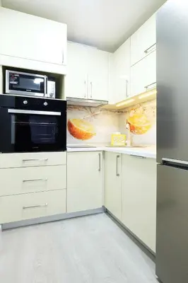 a kitchen with white cabinets and black appliances at Apartment Paradise SunShine in Belgrade