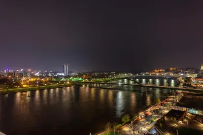 a view of a river at night with a city at Queen Apartments Belgrade Waterfront in Belgrade