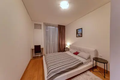 a white bedroom with a bed and a window at Queen Apartments Belgrade Waterfront in Belgrade