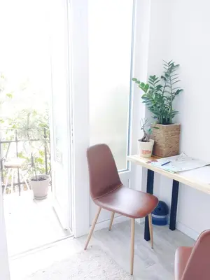 a desk and chair in a room with a window at Cricket Park Hostel in Belgrade